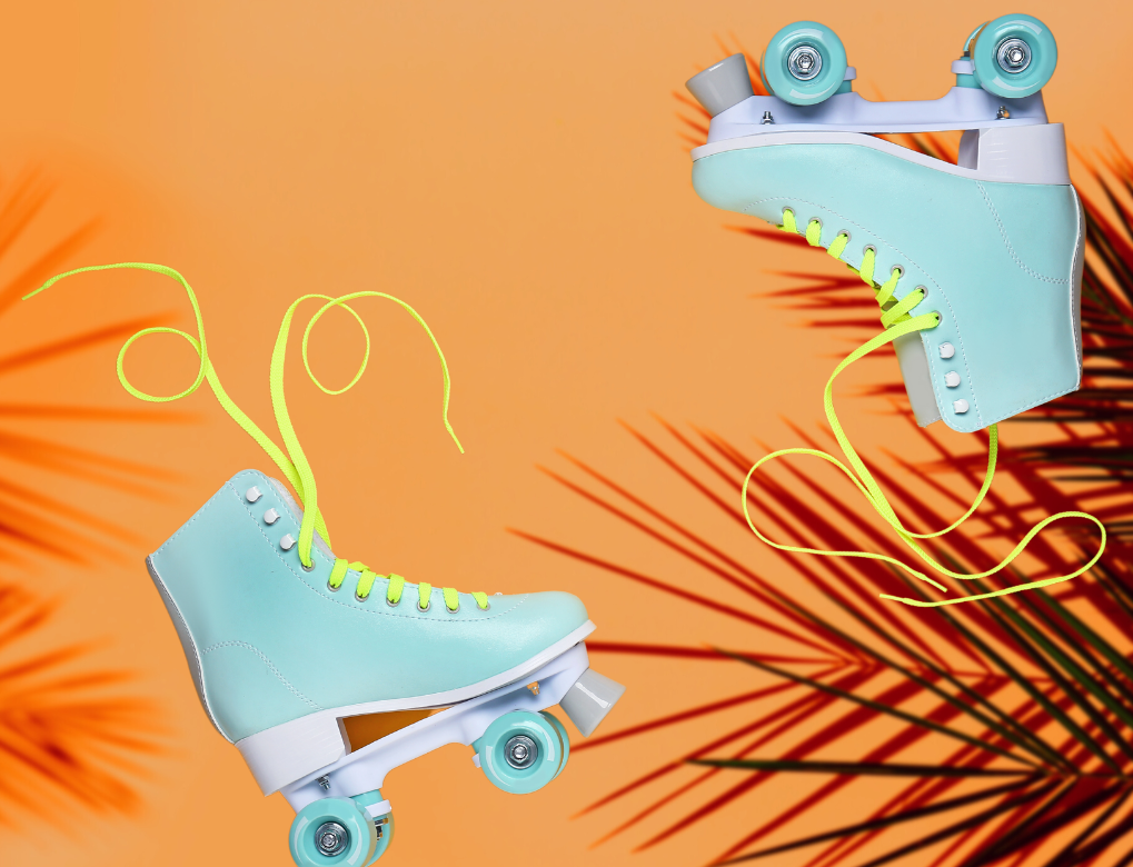 Two blue skates on an orange background with palm